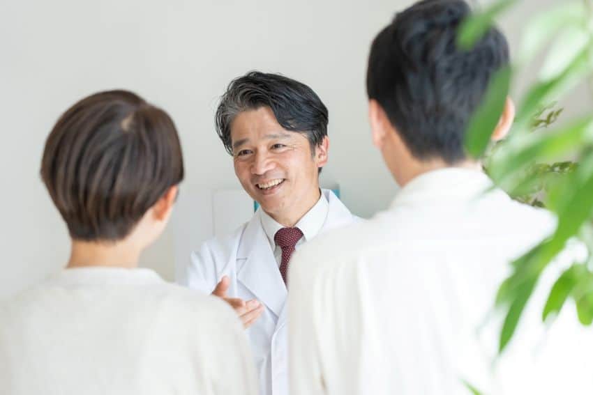 A couple facing male infertility issues consulting with an obstetrician.