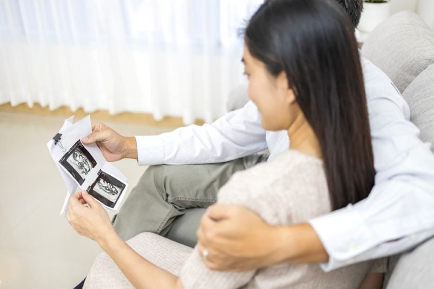 a couple looking at ultrasound results from a fertility test