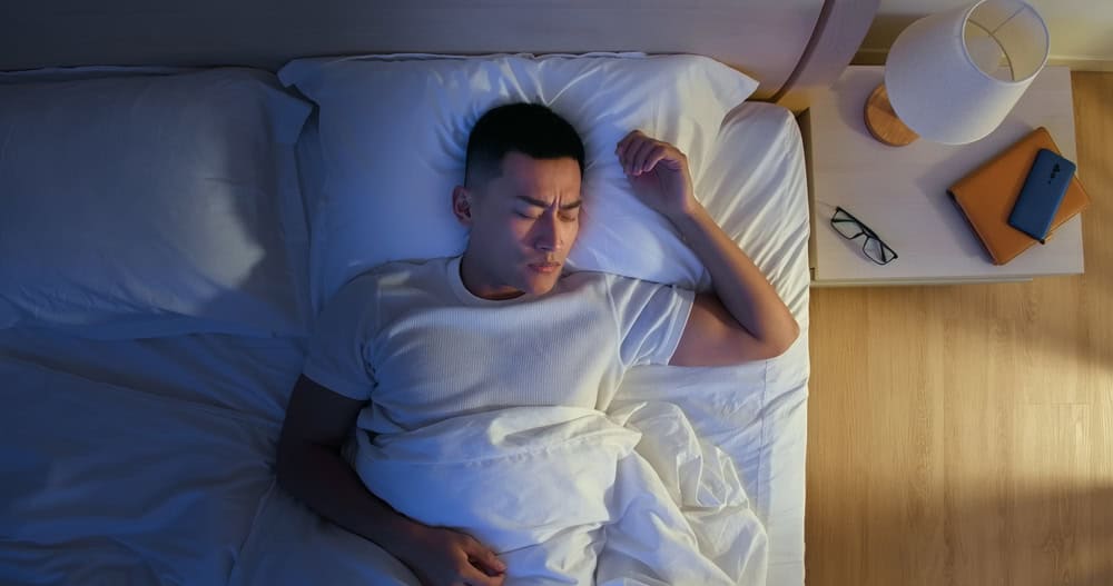 Man experiencing sleep deprivation, leading to reduced sex hormones.