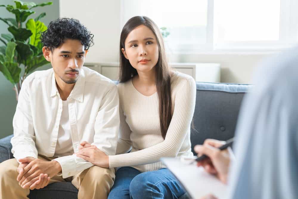 A couple consulting a doctor after an embryo transfer failed.