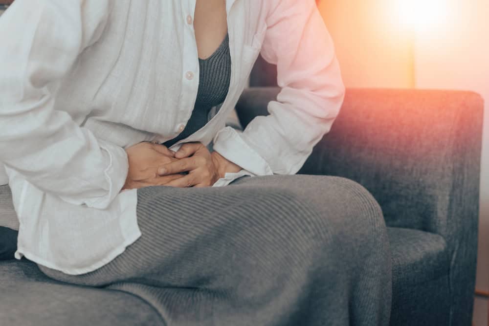 Woman experiencing lower abdominal pain caused by ectopic pregnanc
