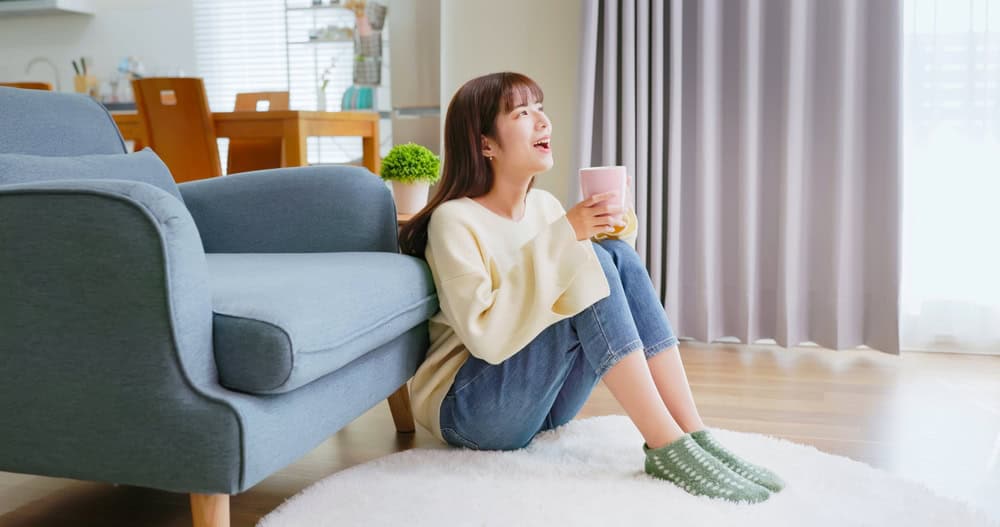 A happy woman relaxing during recovery after uterine fibroid surgery.