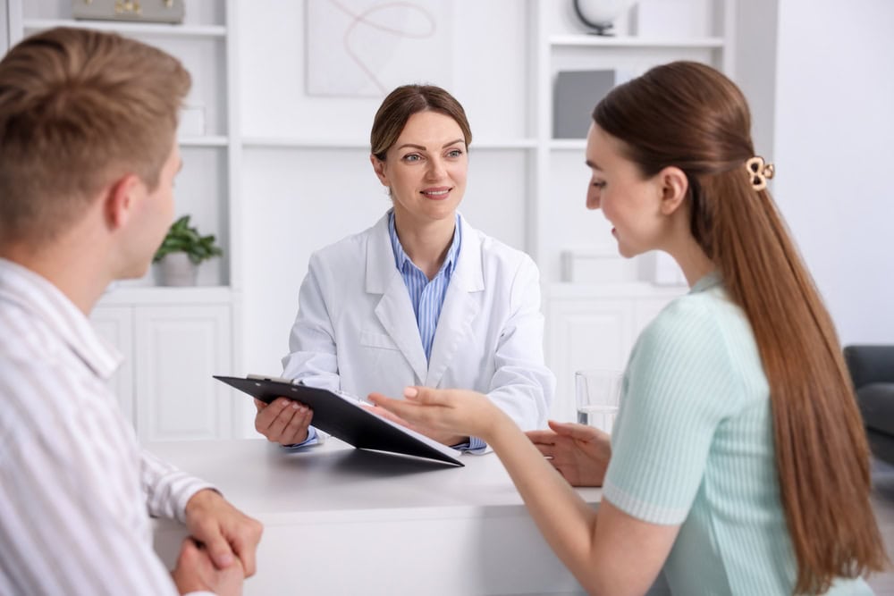 A couple receiving a consultation regarding the PGT-M test.