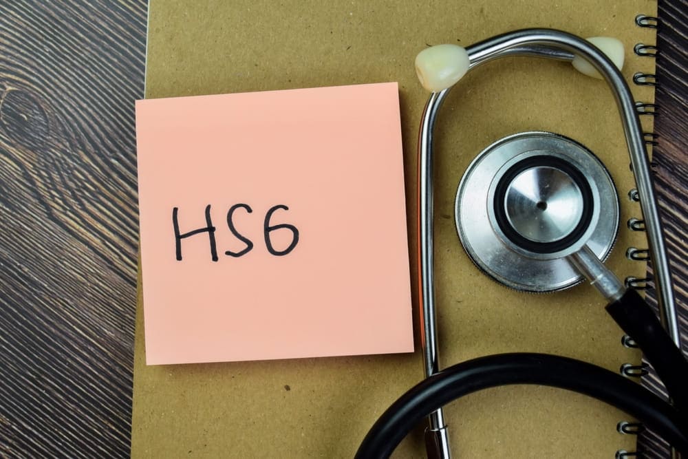 Medical equipment and notes preparing for a fallopian tube dye test.