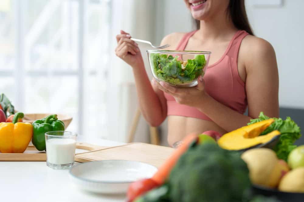 Woman eating healthy food while preparing before embryo transfer